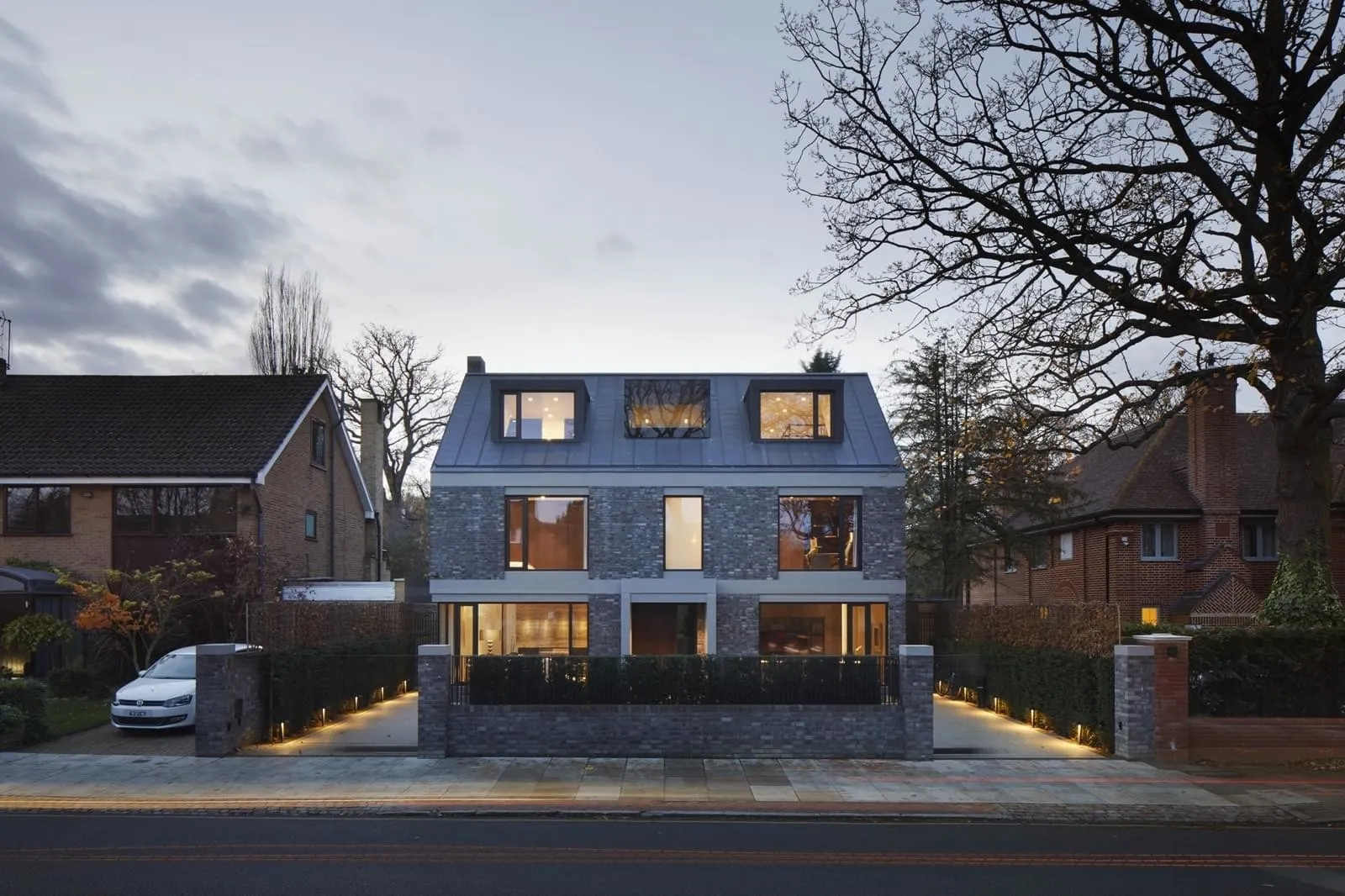Modern house with brick exterior and large windows.