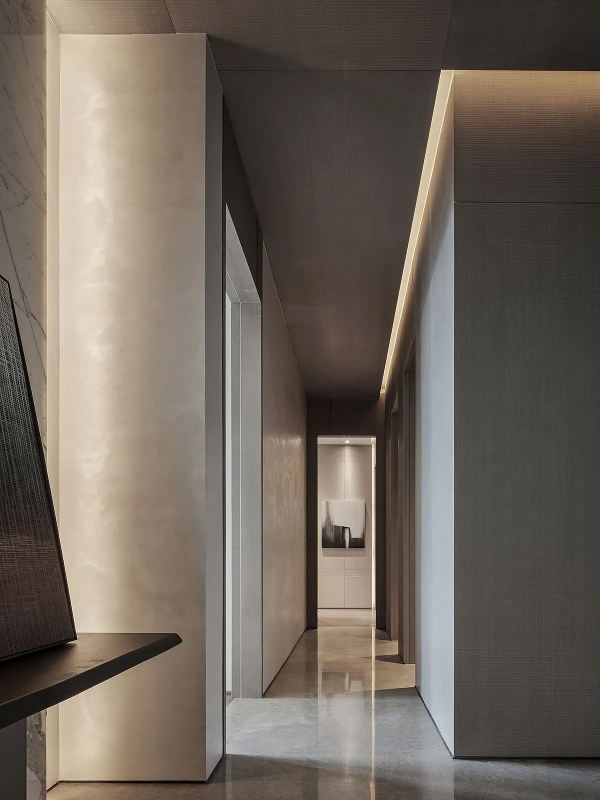 Minimalist corridor featuring polished concrete flooring and walls with industrial lighting.