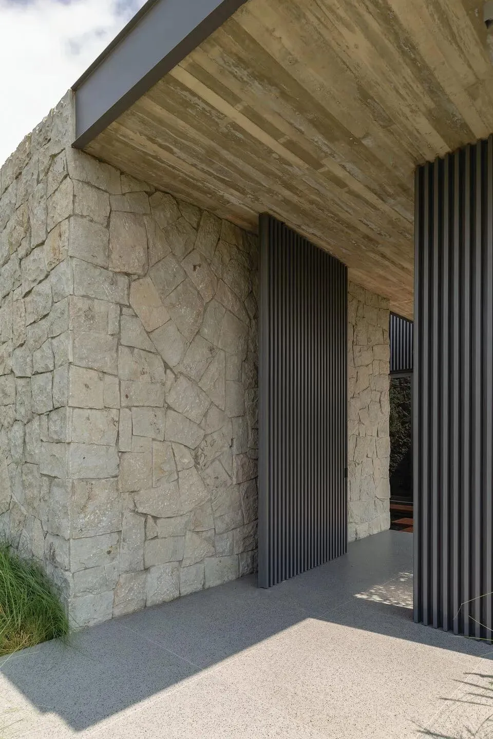 Concrete and stone entryway with a modern design.