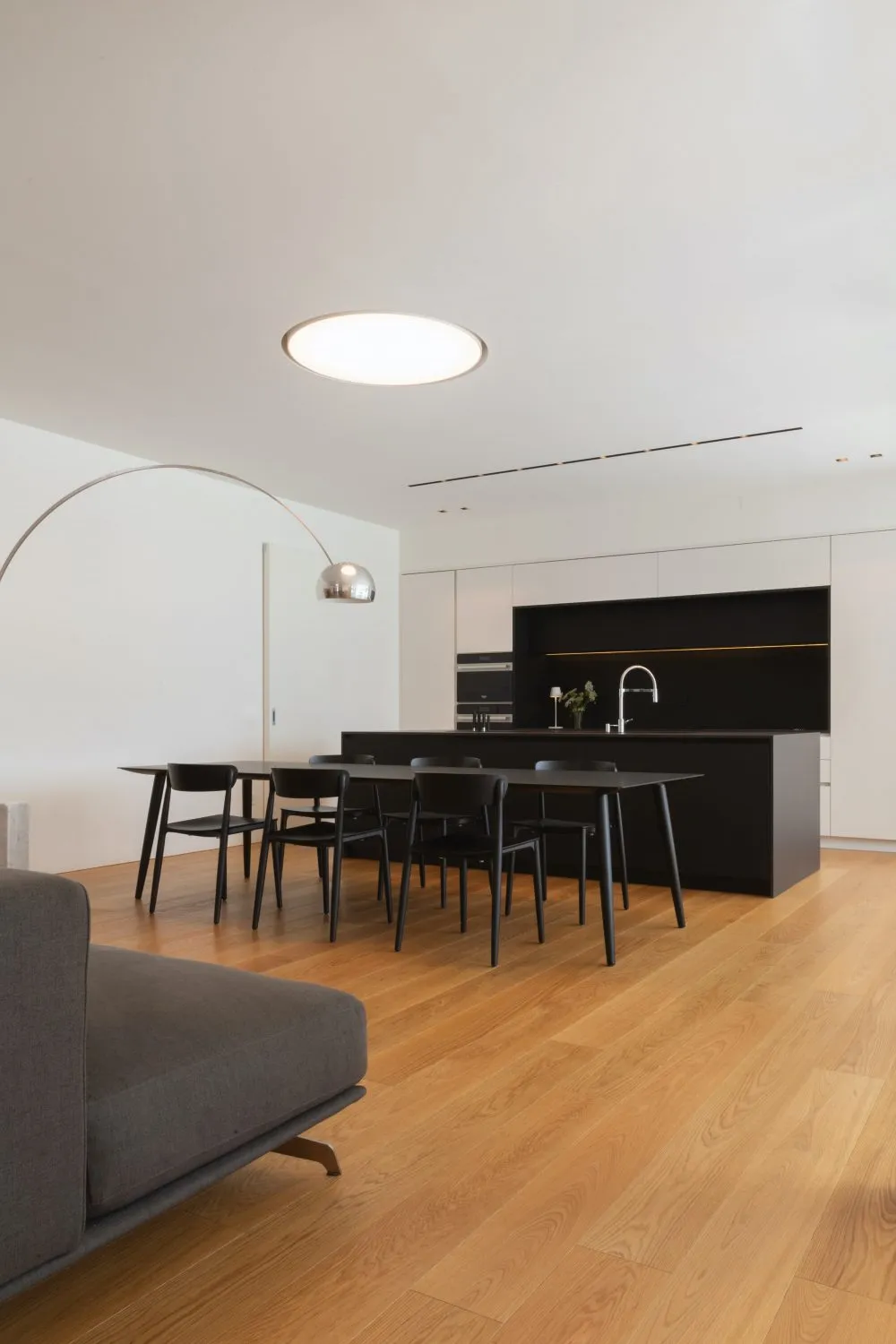 Contemporary dining room featuring black and white furniture and a minimalist design aesthetic.