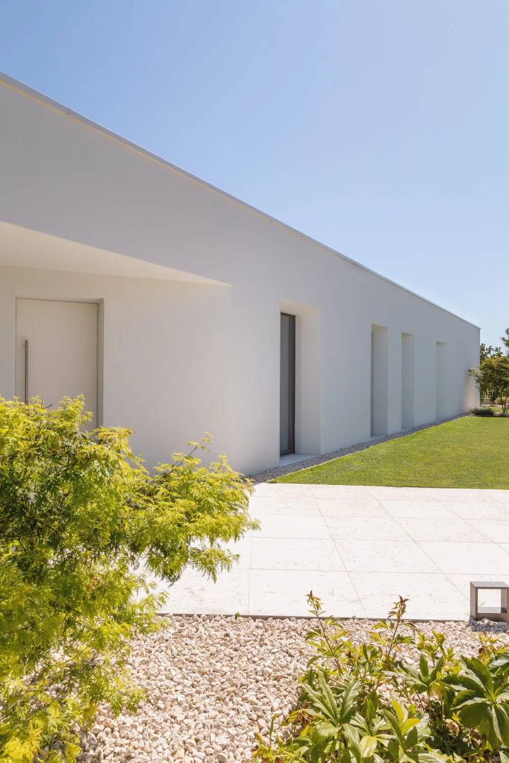 Modern residential home featuring white stucco exterior with minimalist design.