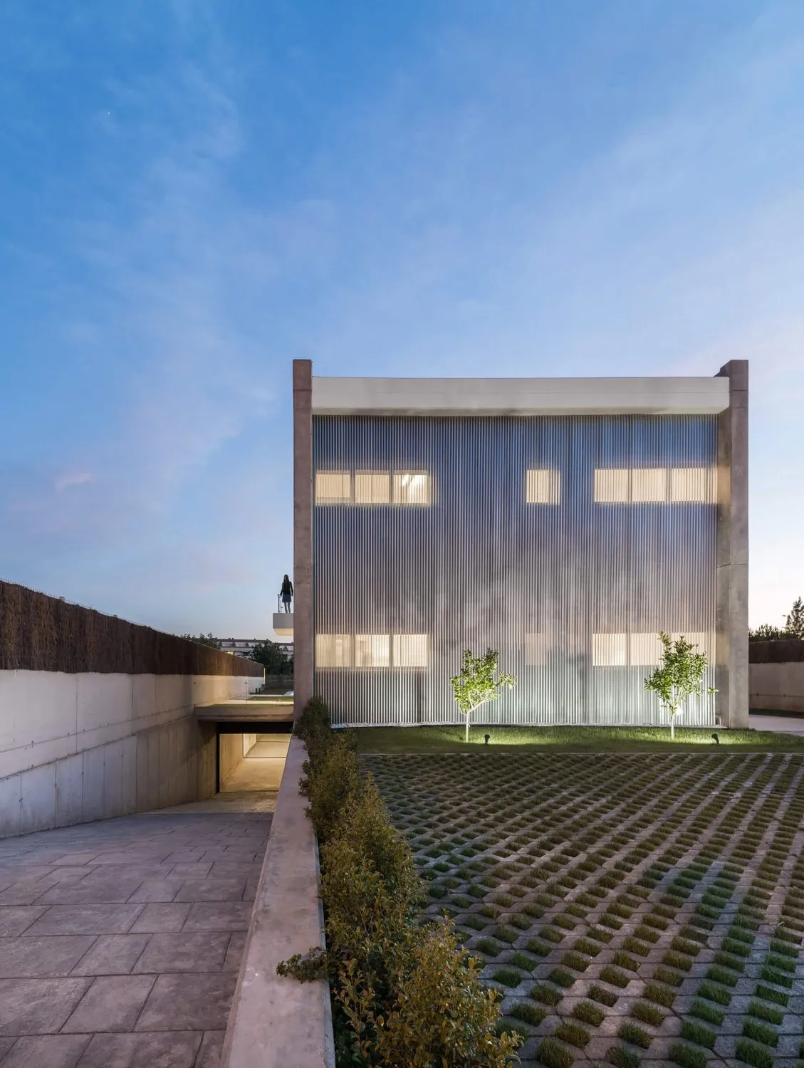 Modern building with metal siding and concrete elements on exterior.