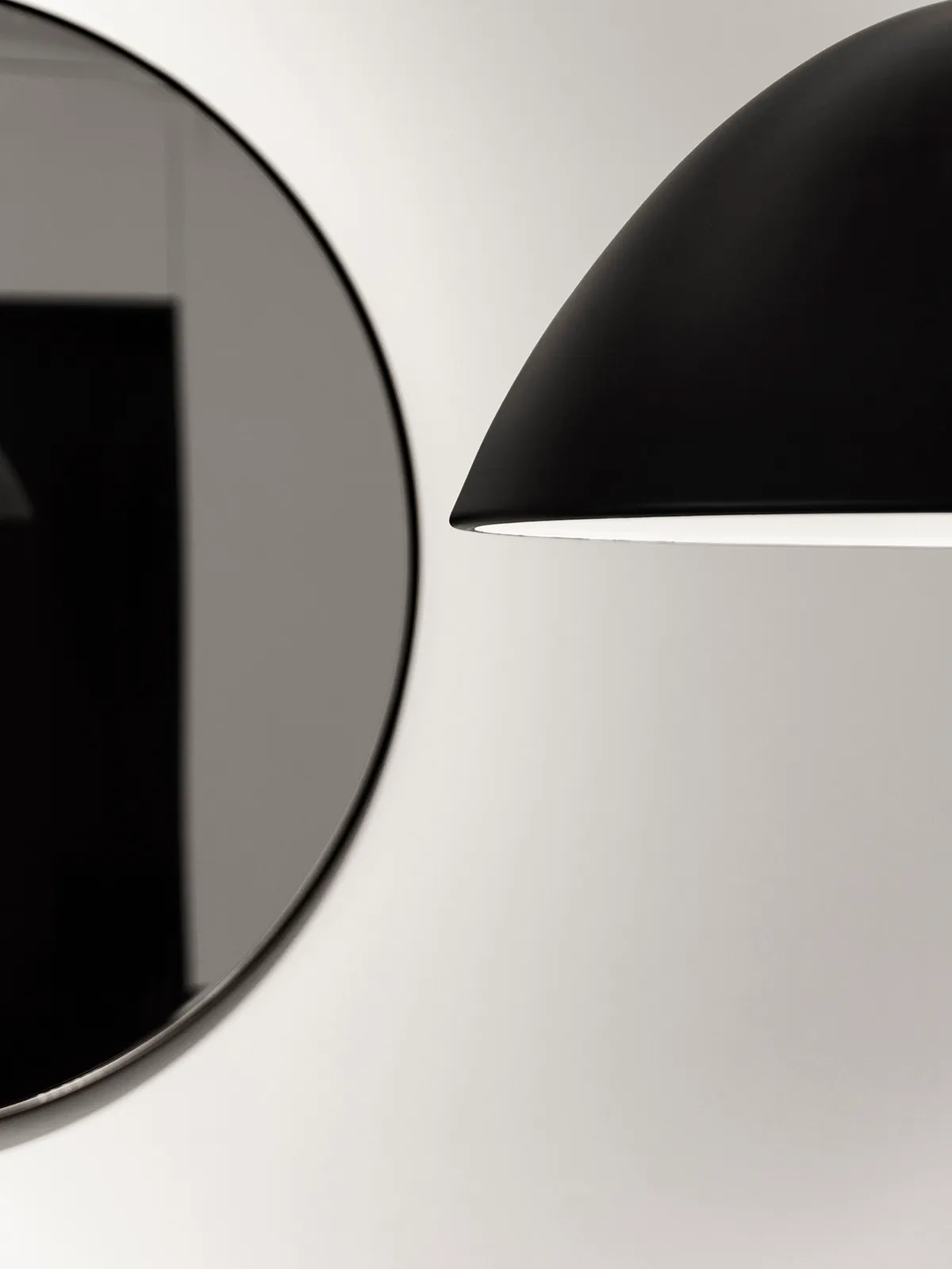 A modern light fixture with a black aluminum shade