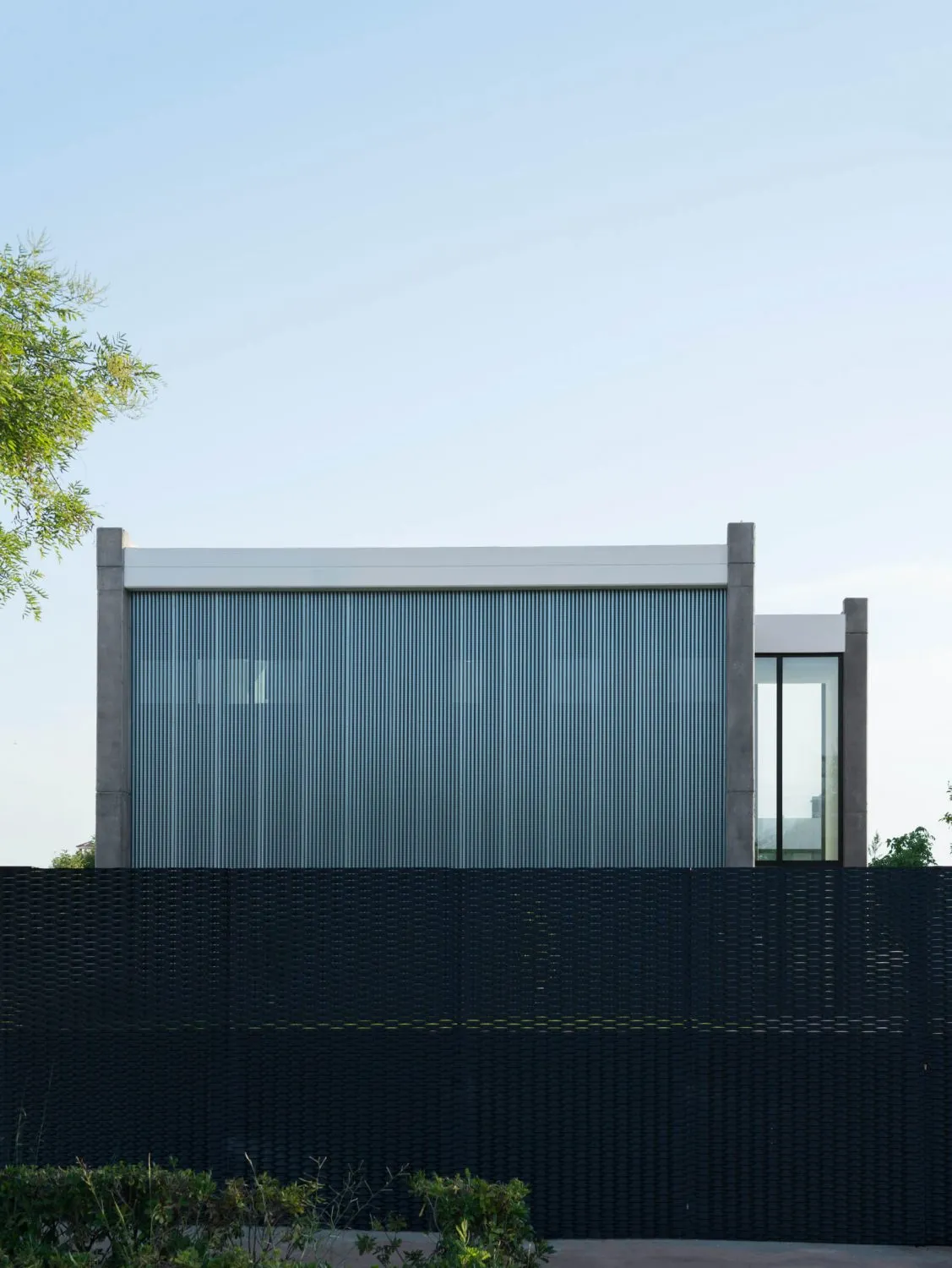 A modern, minimalist residential exterior with metal cladding.