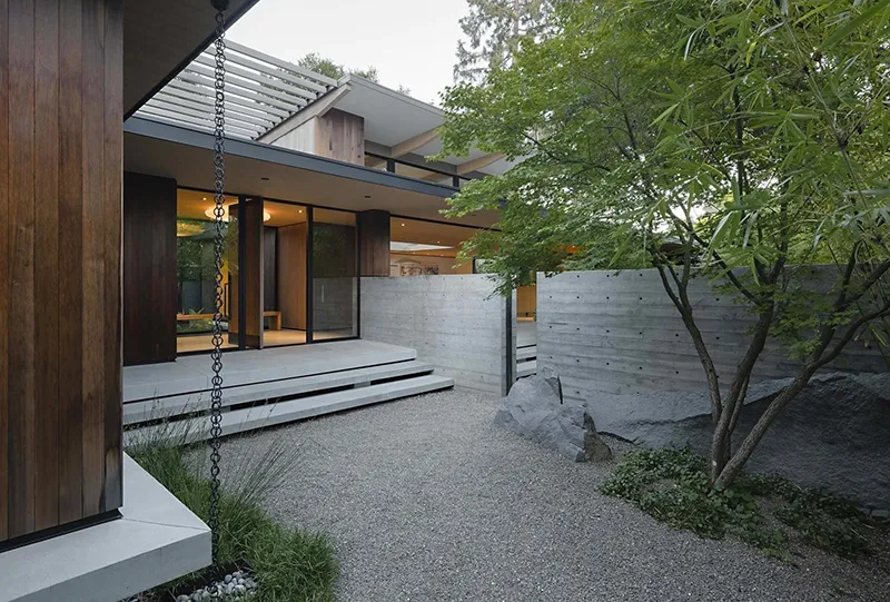 Modern entryway featuring concrete and wood elements.