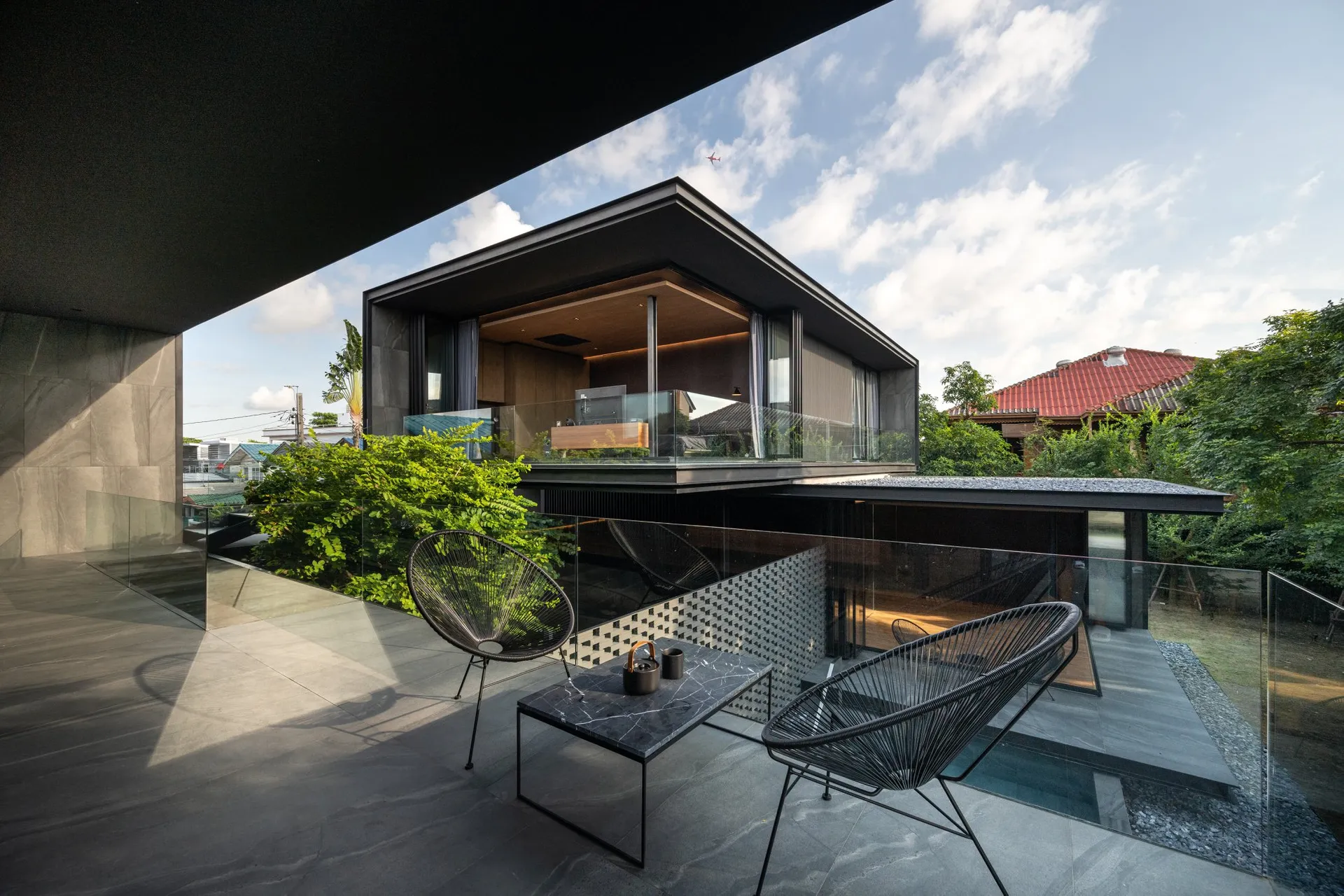 Modern living space featuring concrete walls and a glass wall.