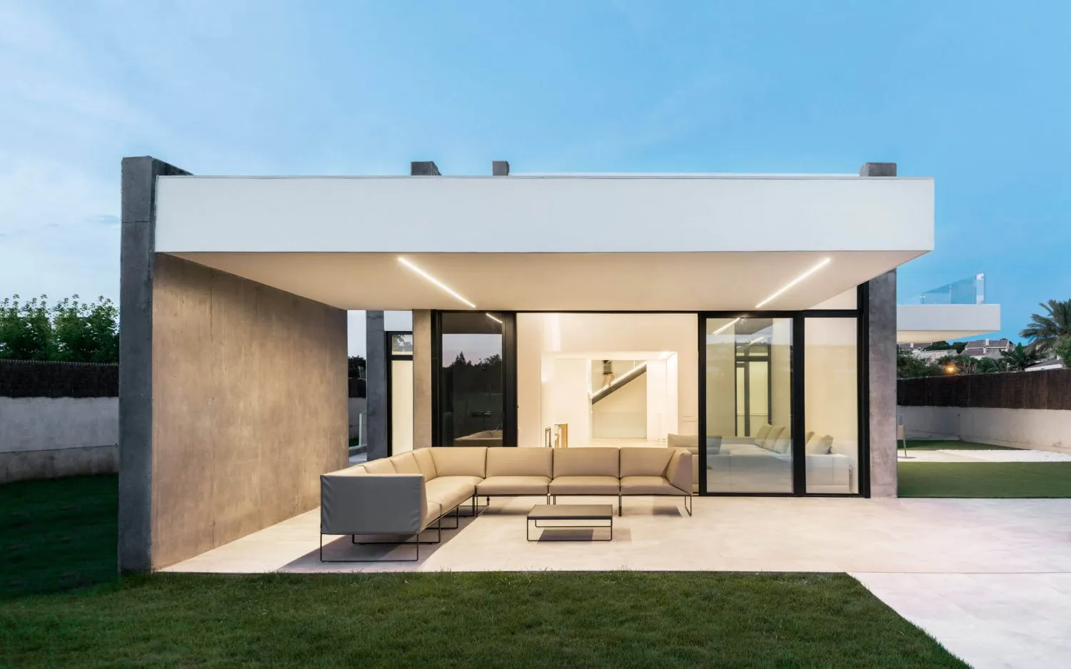 Modern residential exterior with concrete and glass materials.
