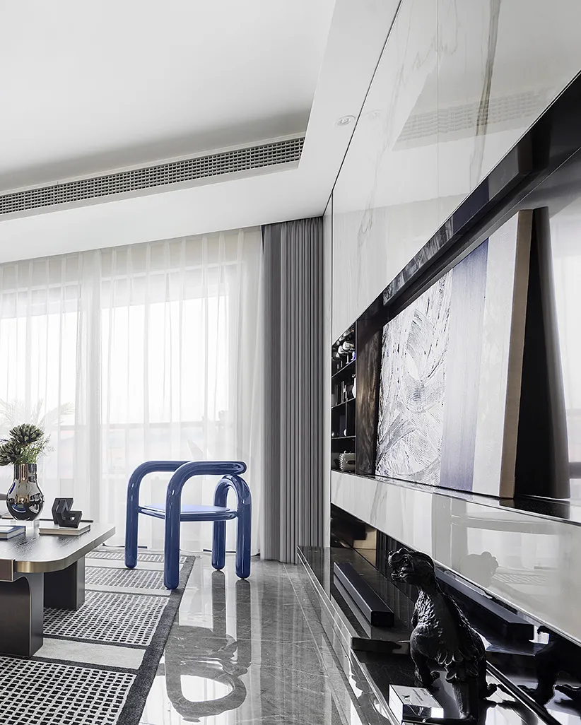 Modern minimalist living room featuring marble and glass elements.
