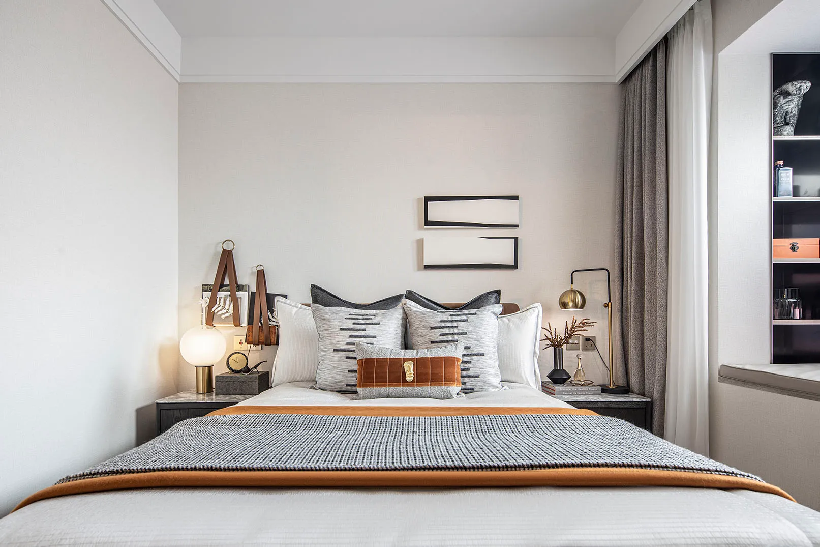 Modern minimalist bedroom with a bed, nightstands, and decorative elements.