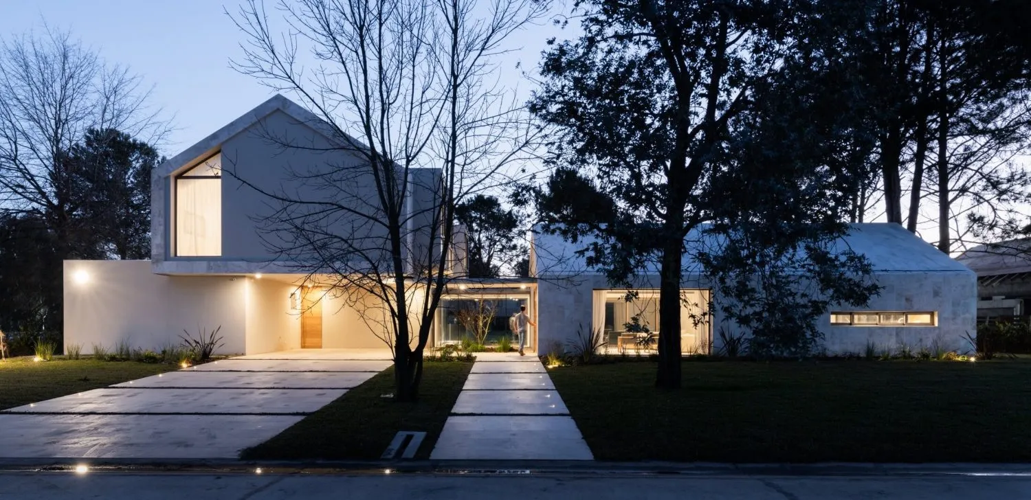 Modern house with concrete exterior and large windows.