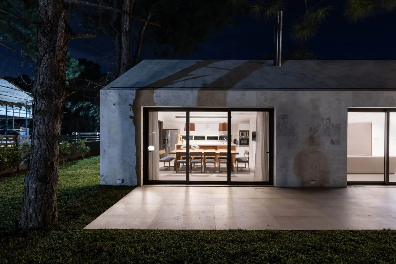 Modern residential building with concrete exterior at night