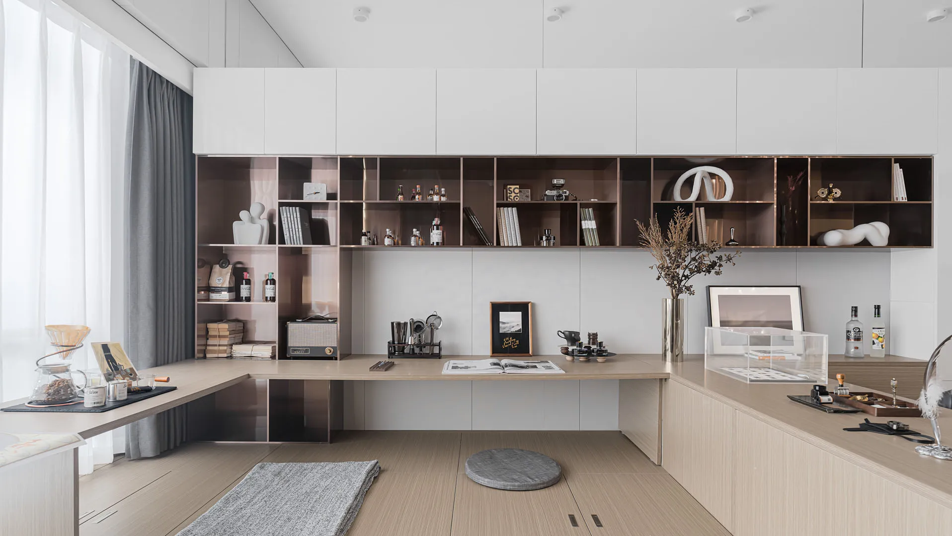 Spacious contemporary living room with wooden furniture, bookshelves, and a large window for natural light.
