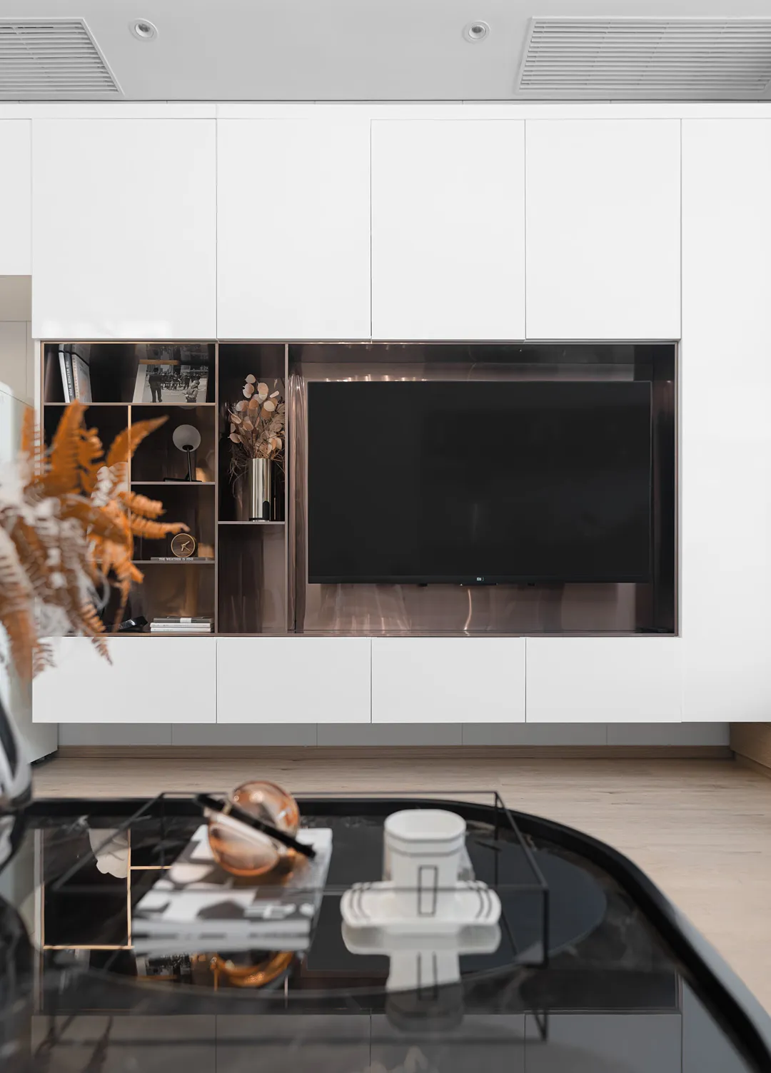 Modern minimalist living room with white paneling and sleek furniture.