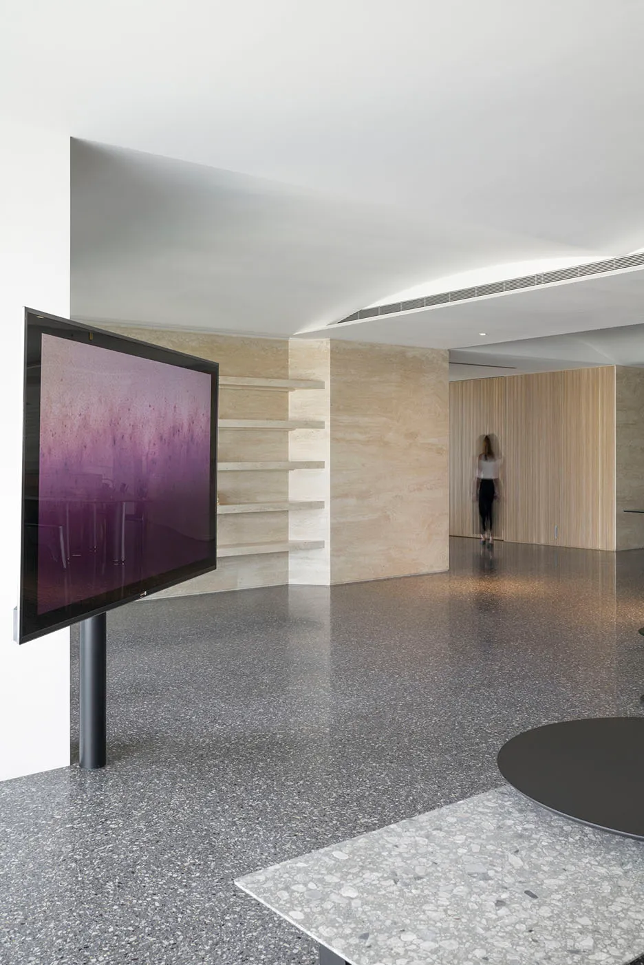 Modern lobby with a terrazzo floor, minimalist design, and contemporary decor.