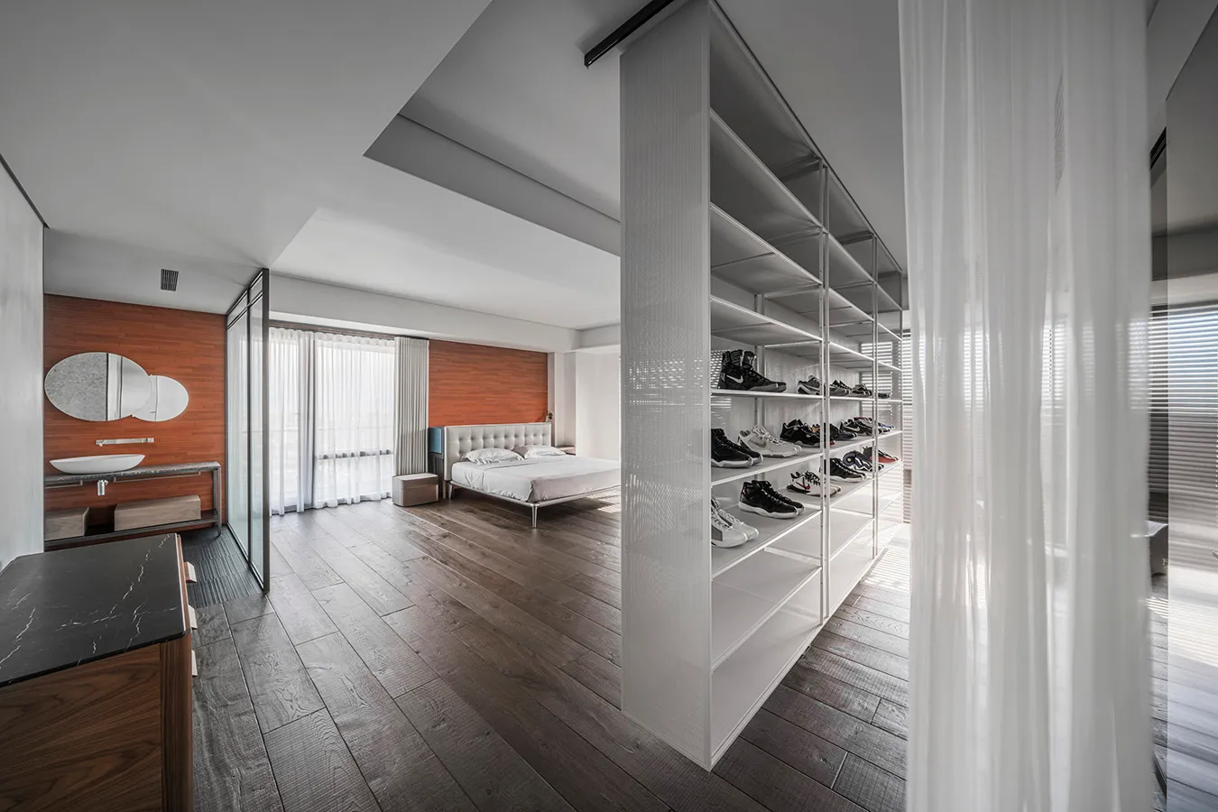 Well-lit, minimalist residential interior designed with wood, glass, and metal.