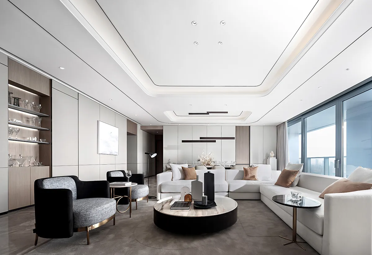 A modern living room with white and black furniture and minimalistic decor.