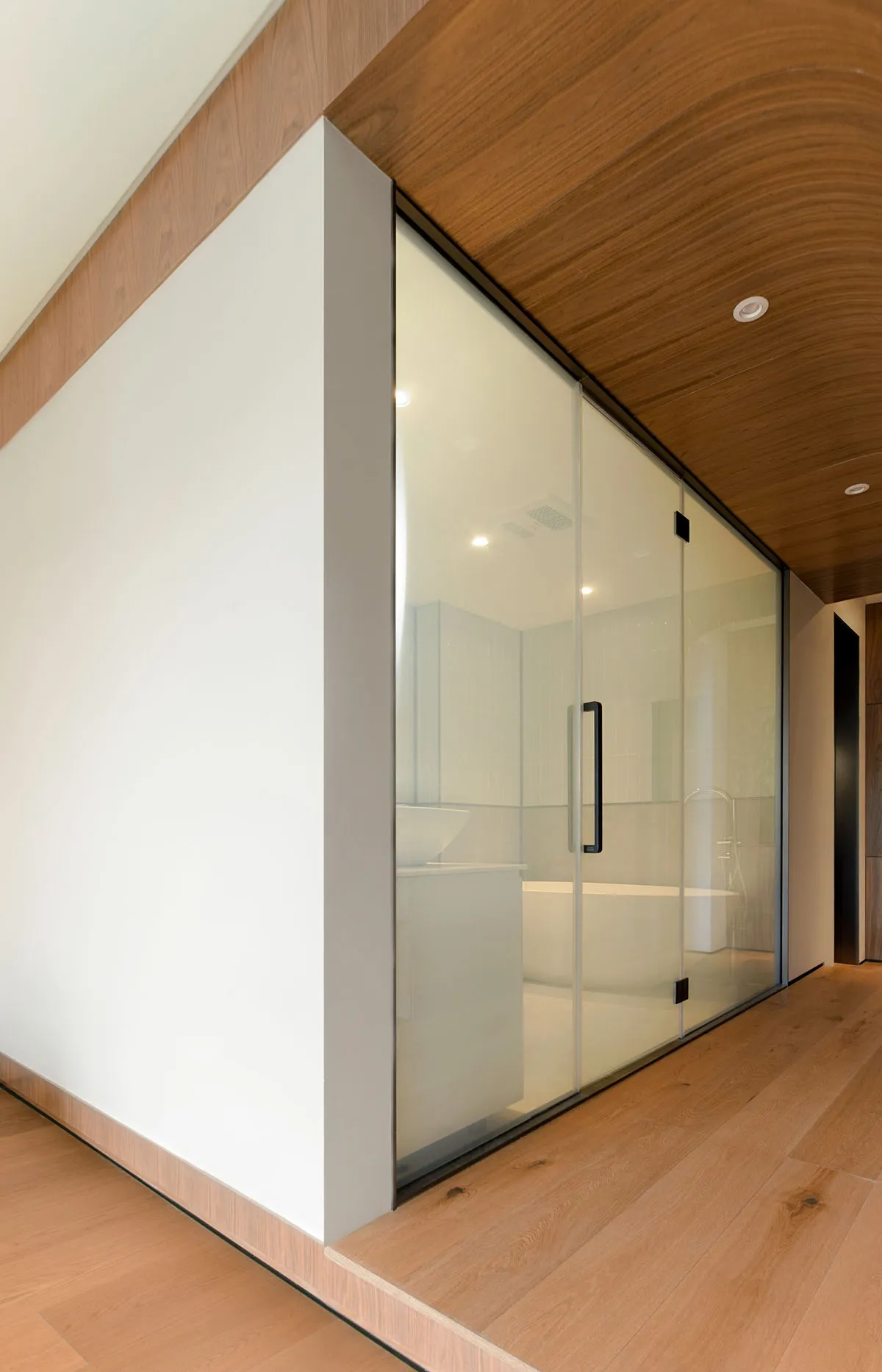 Modern minimalist bathroom featuring a glass shower door.