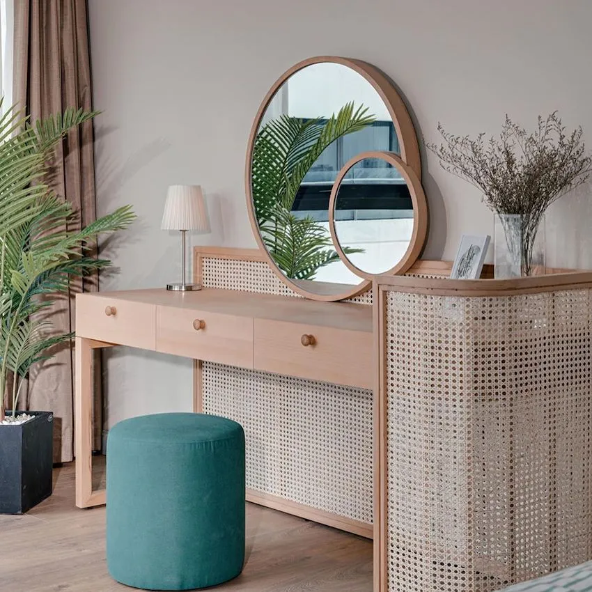 Modern bedroom with a wooden vanity, green stool, and circular mirrors.
