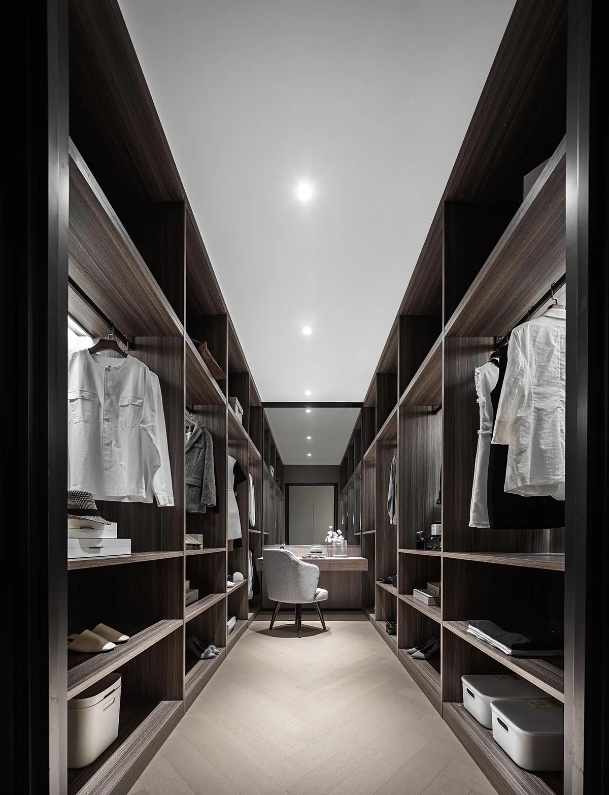 Modern industrial-style closet with wooden shelves and clothing items.