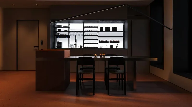 A modern minimalist residential kitchen with metallic cabinets, glass shelves, and wooden dining chairs.