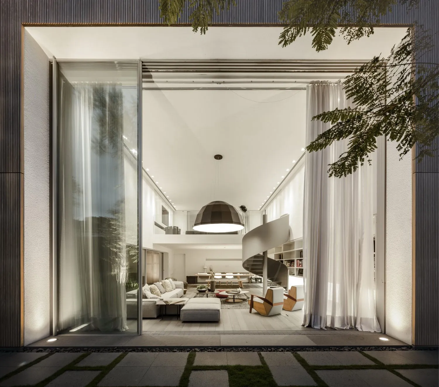 Modern residential interior with glass walls and wooden furniture.
