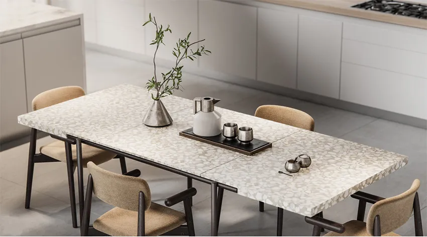 Modern dining room featuring a terrazzo table with a vase of greenery, a kettle, and salt and pepper shakers on a wooden tabl