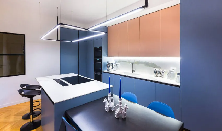 A modern kitchen with blue countertops, featuring sleek, minimalist design elements and a clean, uncluttered aesthetic.