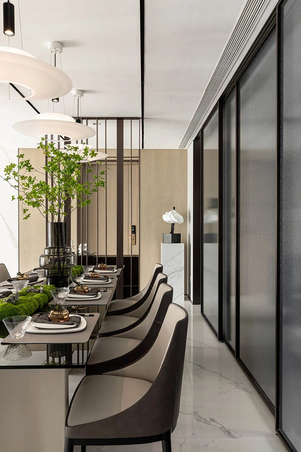 Contemporary dining room with glass tables and leather chairs