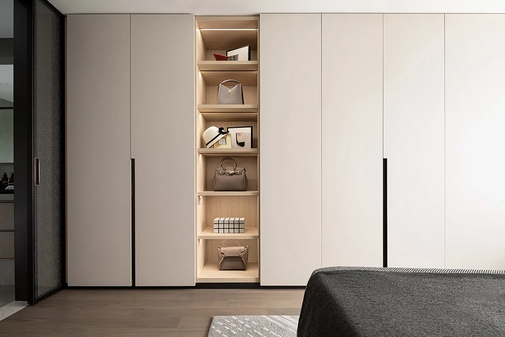 Modern minimalist closet storage system with light wood shelving and steel accents.