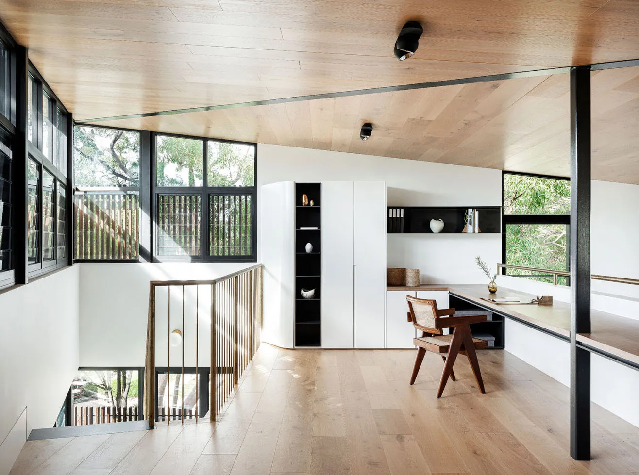 Modern office interior with a floating desk and large windows.