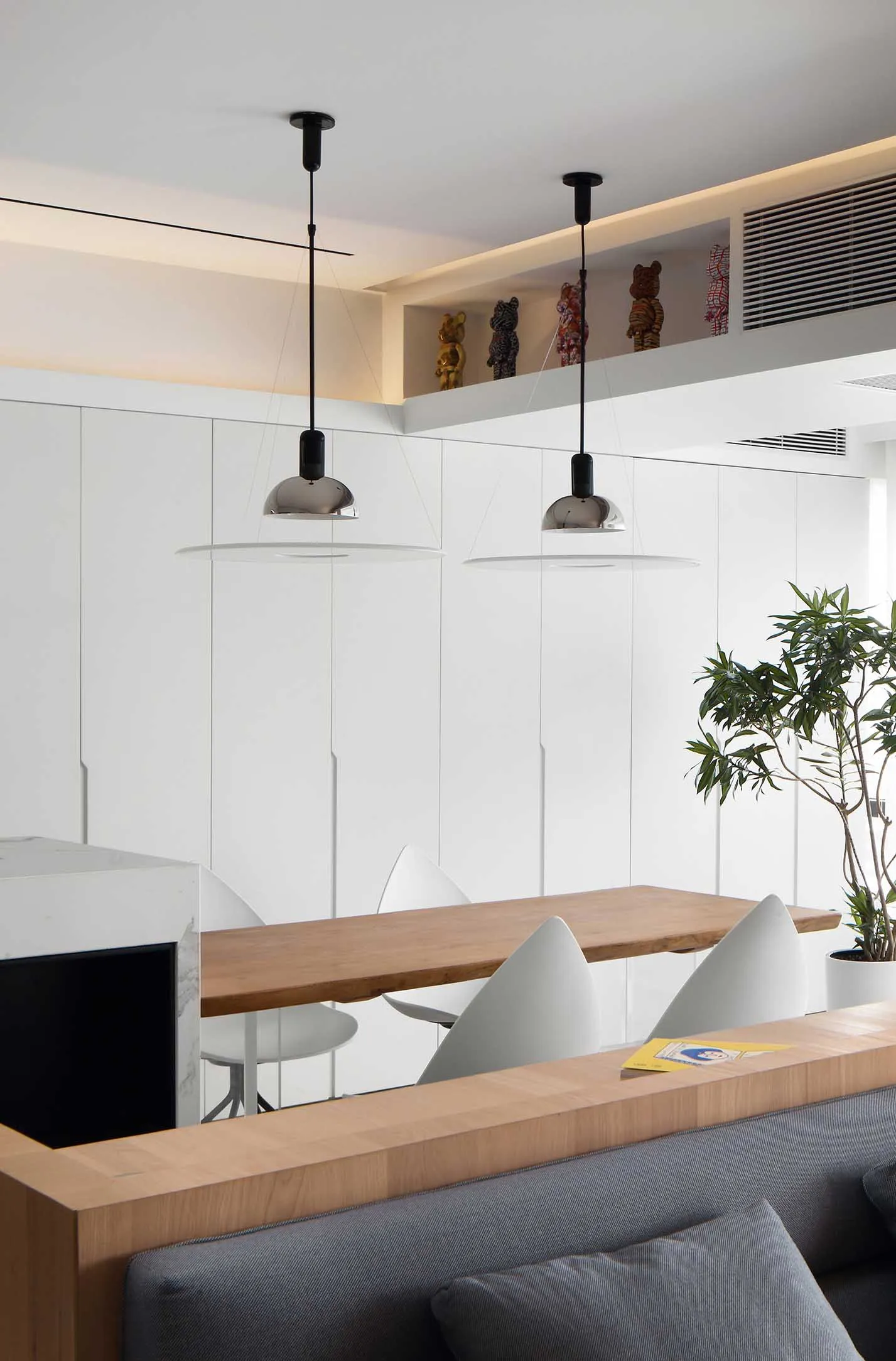 Modern interior design featuring a white wall with wood and metal elements.