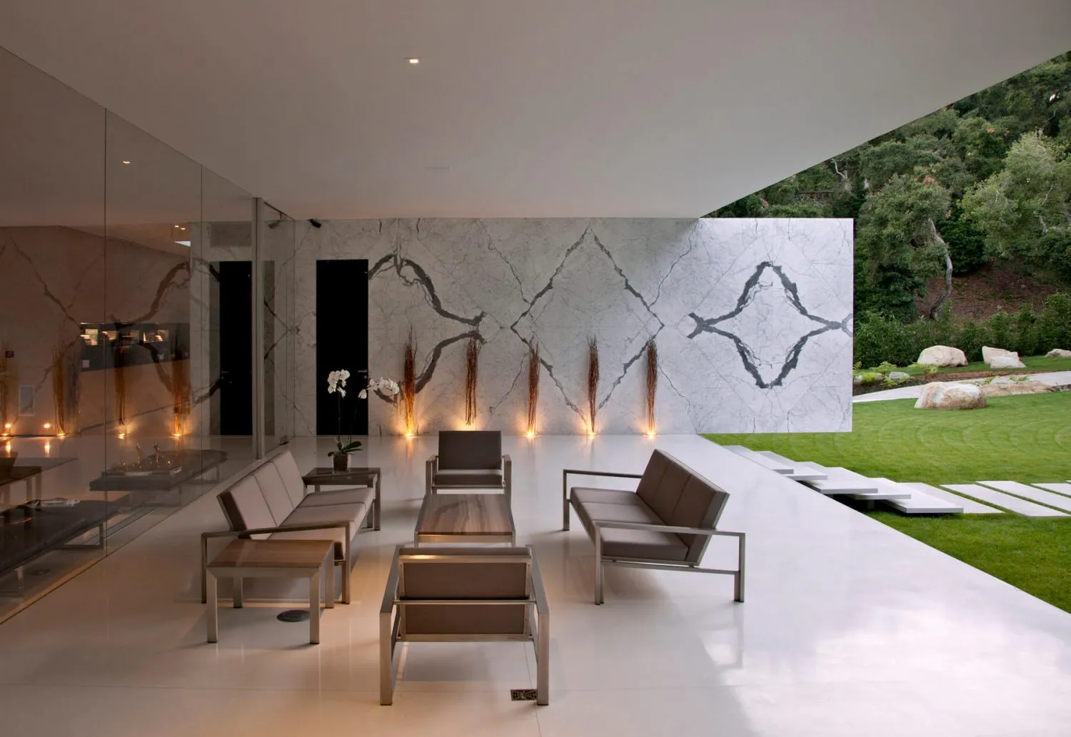 A modern minimalist interior space featuring concrete and glass materials.
