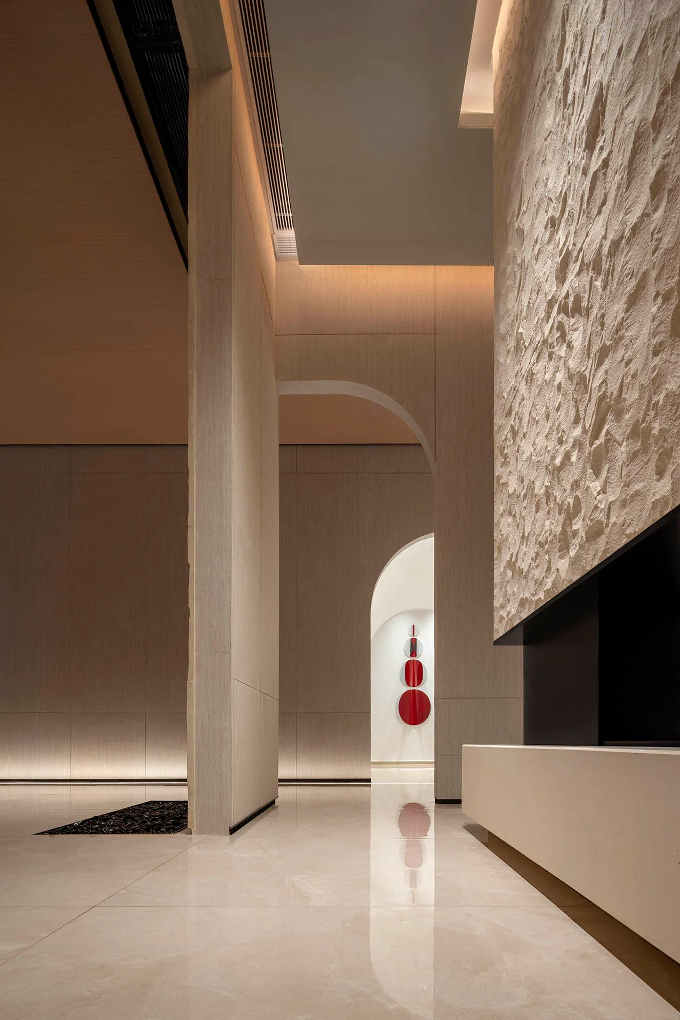 A modern lobby with concrete walls and marble floors.