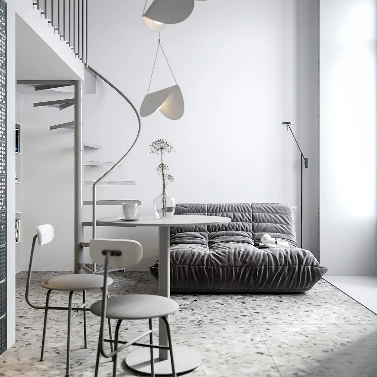 A minimalist living room with a gray sofa, a white round table, two white chairs, and a spiral staircase with a white hanging