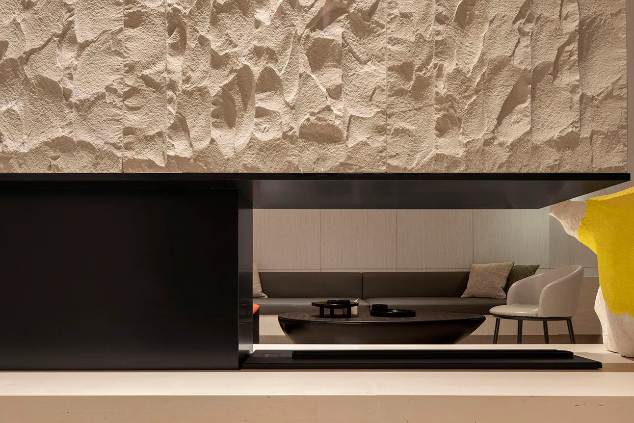 Modern living room with concrete textured walls and minimalist furniture.