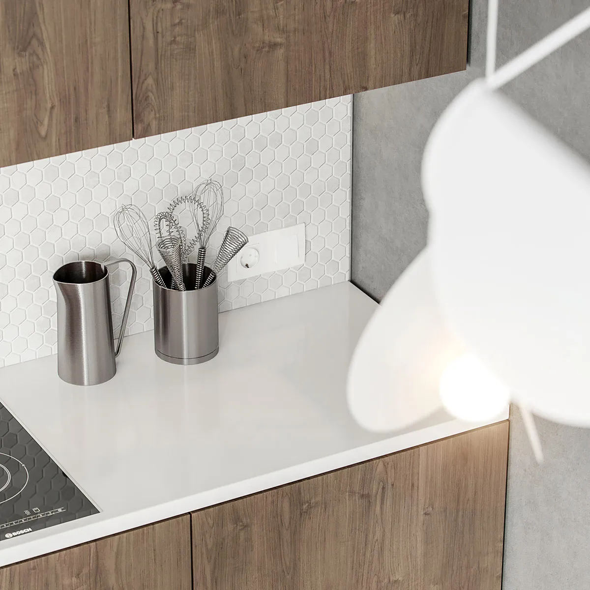 A modern kitchen featuring metallic containers and concrete countertops against a wooden cabinet background.