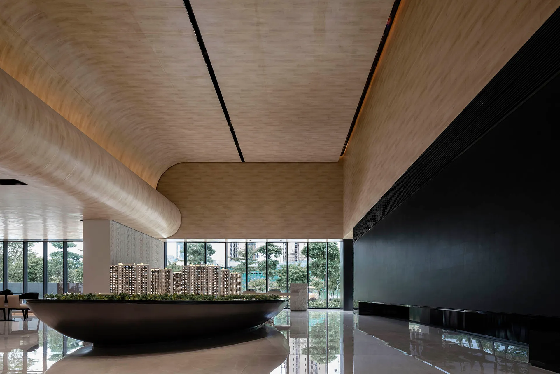 Modern lobby with concrete and glass walls and a wooden ceiling