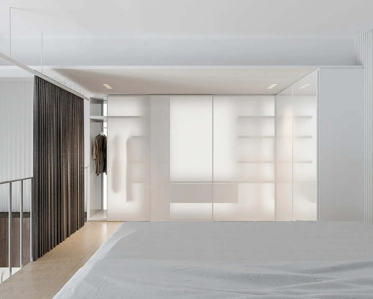 Modern minimalist bedroom featuring glass panel furniture and LED lighting under white ceiling and wooden floor.