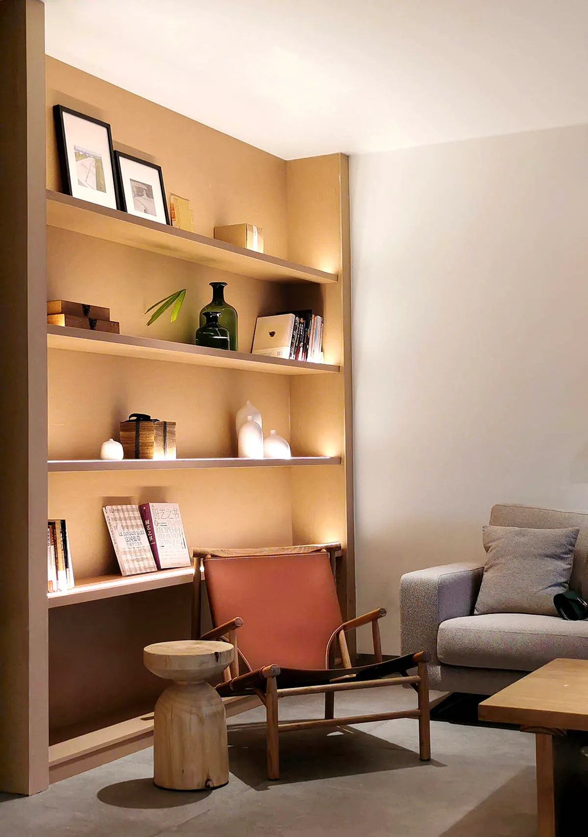 Modern minimalist living room with wood accents and a cozy seating area.