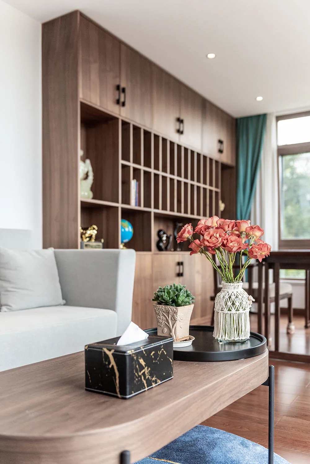 A modern living room featuring wooden furniture and decorative accents.