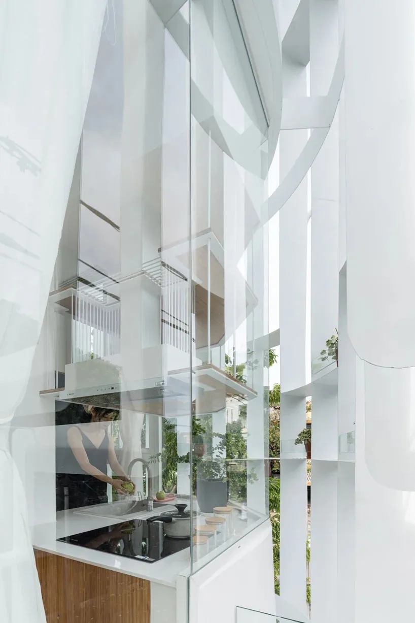 A modern residential kitchen designed with glass panes, featuring a sleek and minimalistic aesthetic.