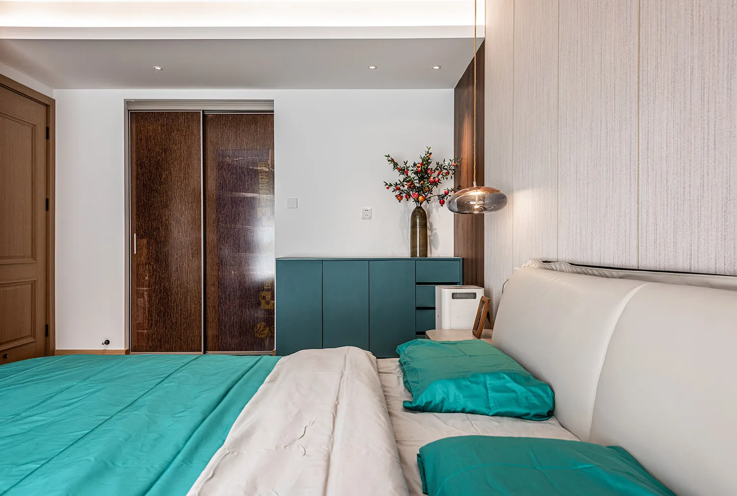 A modern bedroom featuring a fabric bed with wood and metal accents.
