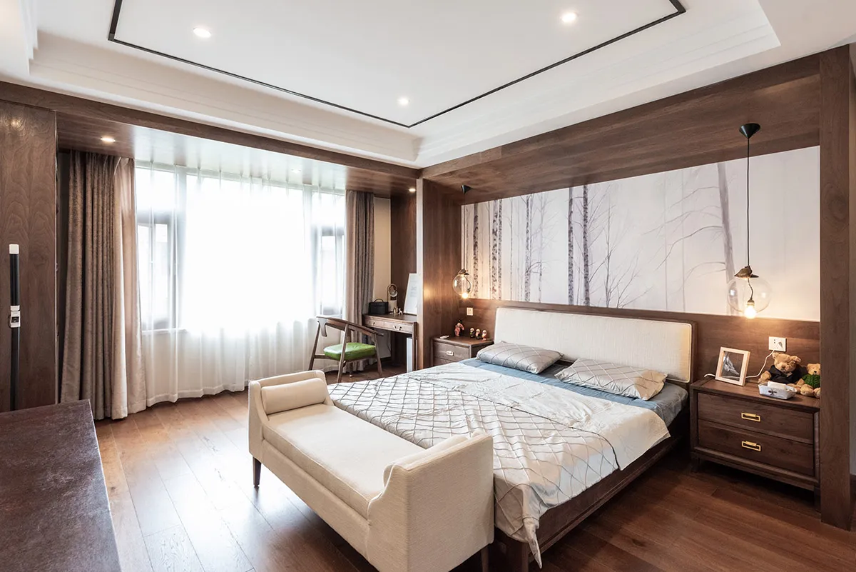 A modern bedroom with a wooden floor, wooden walls, and a white bed.