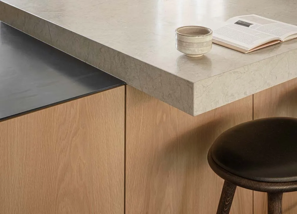 A minimalist modern kitchen with a concrete countertop.