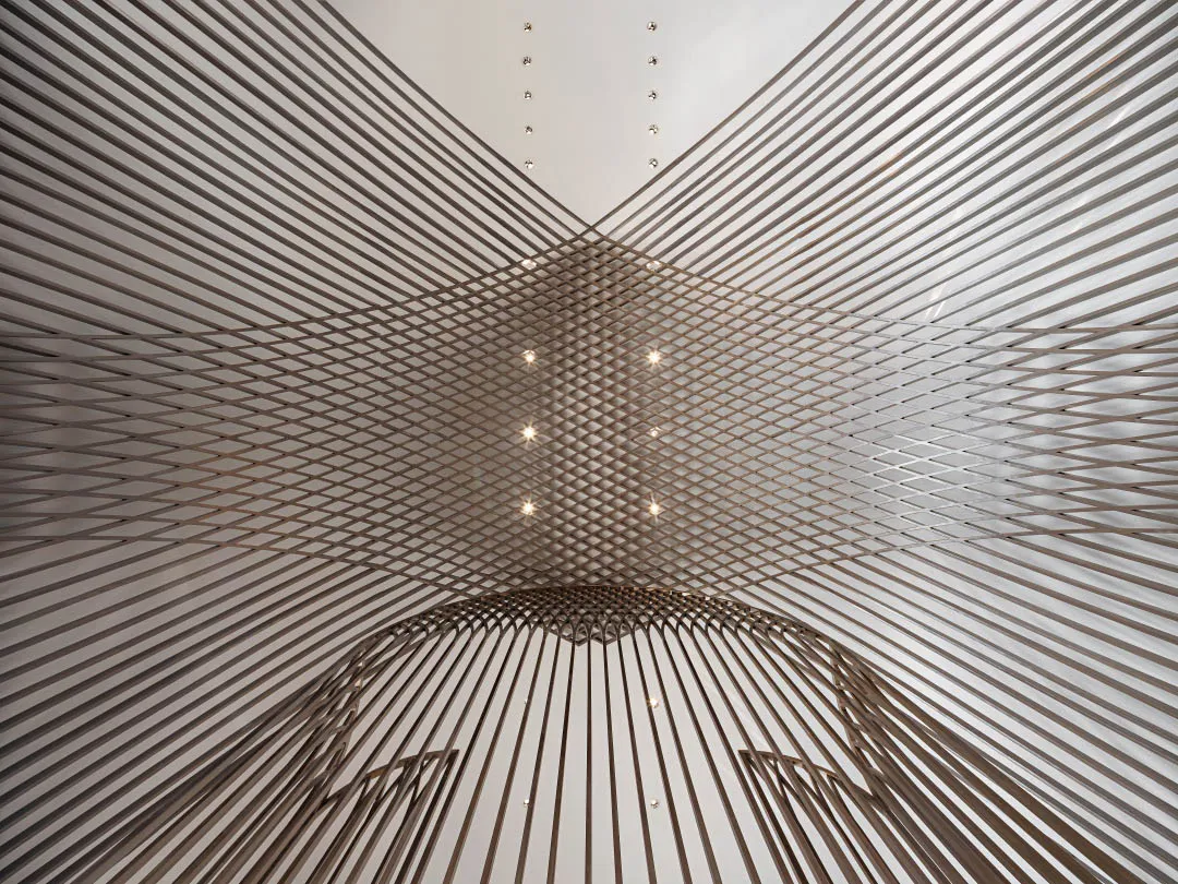 A modern industrial-style ceiling with geometric lighting fixtures creating a unique pattern.