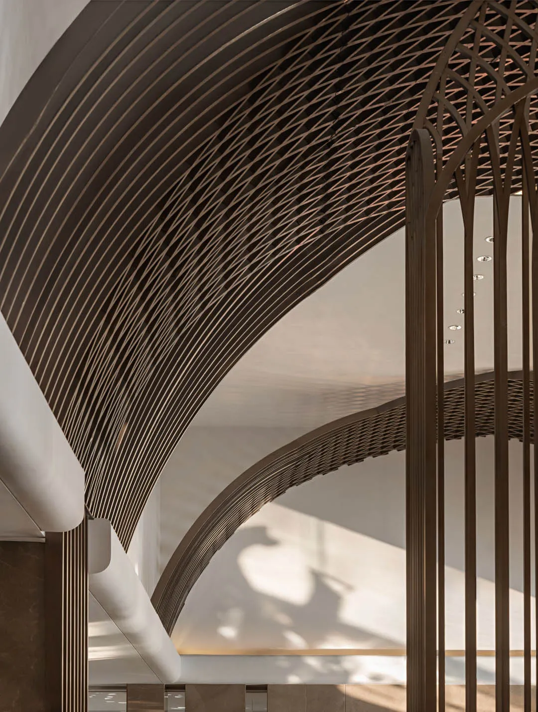 Modern interior design featuring a metallic mesh ceiling and curved lines.