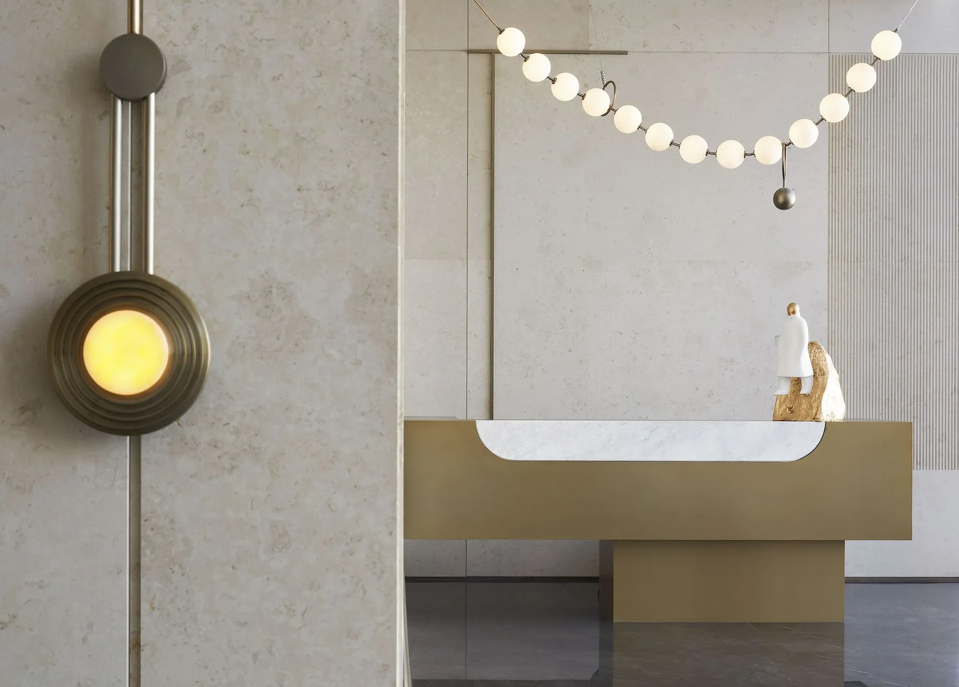 A modern, minimalist reception desk with a metallic finish, featuring a sleek design and clean lines.