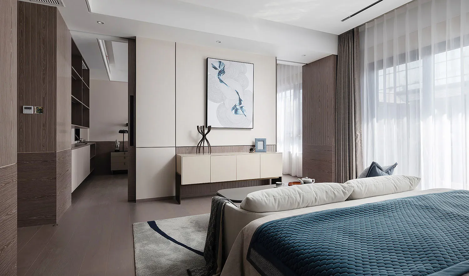 Modern bedroom with white walls, wooden furniture, and glass panel window