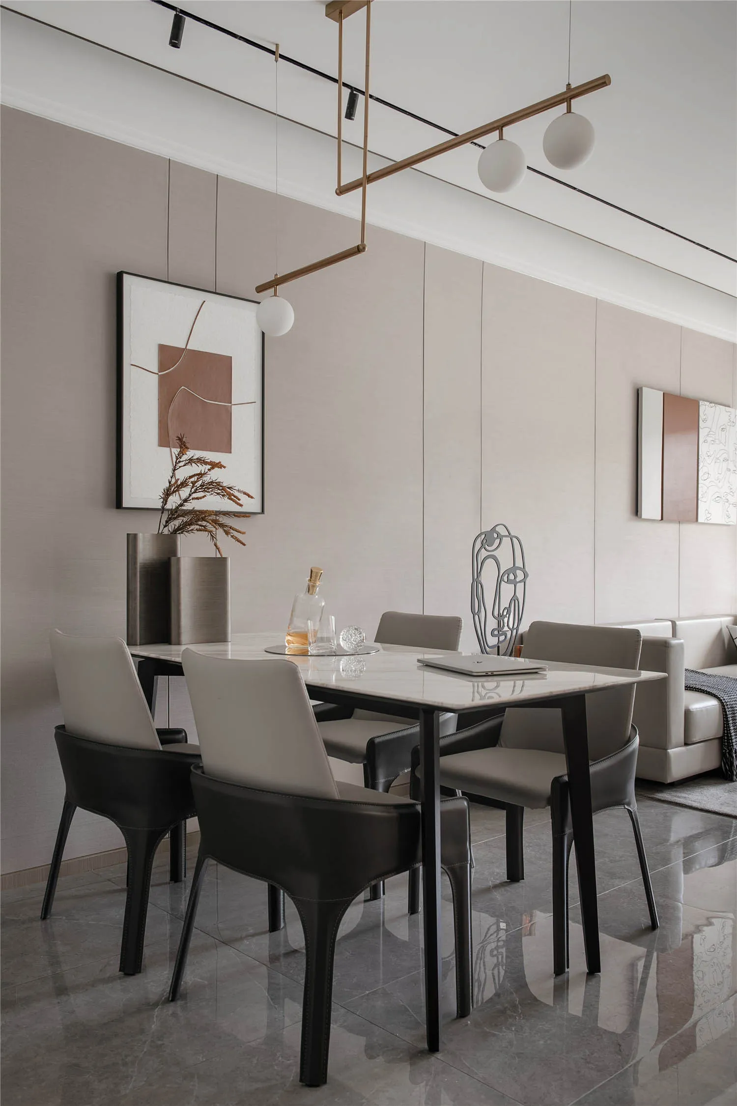 Modern dining room with marble table and black leather chairs