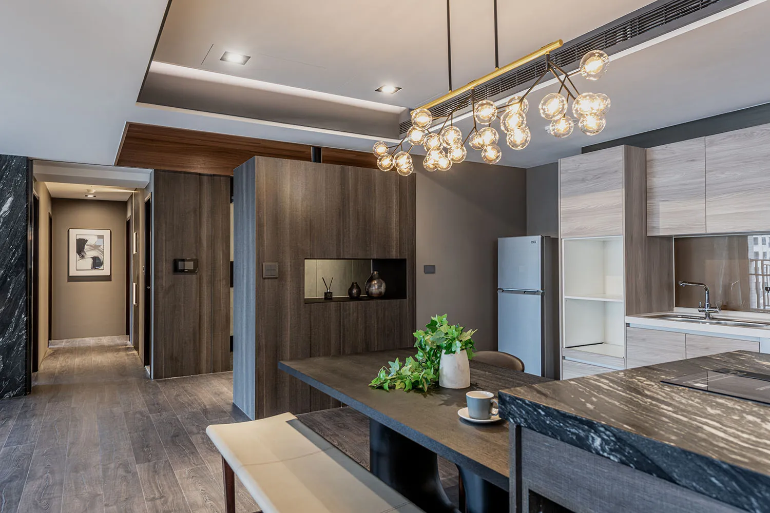 Modern residential kitchen featuring wood and marble finishes